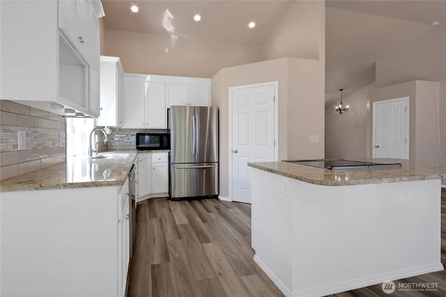15127 148th Avenue Ct E, Orting, WA 98360 - kitchen featuring black appliances, a sink, light wood-type flooring, white cabinets, and high vaulted ceiling
