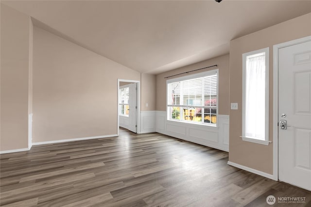 15127 148th Avenue Ct E, Orting, WA 98360 - entryway with vaulted ceiling, wood finished floors, and a wainscoted wall