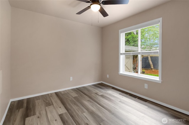 15127 148th Avenue Ct E, Orting, WA 98360 - empty room with wood finished floors, baseboards, and ceiling fan