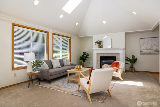 3901 Sterling Pl, Anacortes, WA 98221 - carpeted living area featuring lofted ceiling, baseboards, a tiled fireplace, recessed lighting, and a skylight