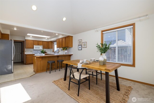 3901 Sterling Pl, Anacortes, WA 98221 - dining space featuring light colored carpet, healthy amount of natural light, recessed lighting, and baseboards