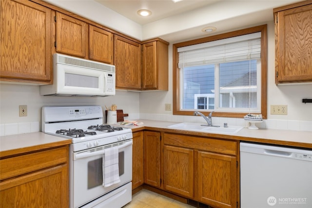 3901 Sterling Pl, Anacortes, WA 98221 - kitchen with white appliances, a sink, brown cabinets, and light countertops