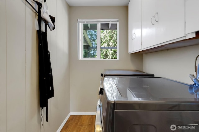 2419 SW 316th St, Federal Way, WA 98023 - washroom featuring cabinet space, washing machine and dryer, wood finished floors, and baseboards
