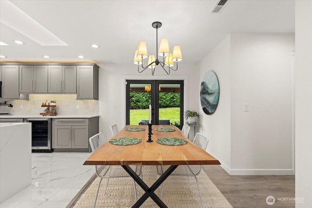 12125 E Woodland Ave, Puyallup, WA 98373 - dining room featuring beverage cooler, recessed lighting, a chandelier, and baseboards