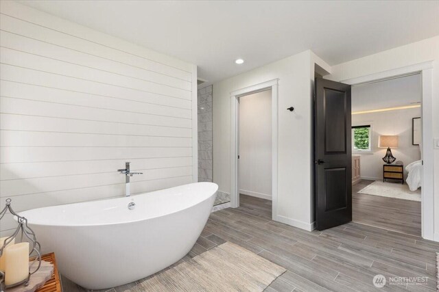 12125 E Woodland Ave, Puyallup, WA 98373 - full bath featuring wood finish floors, baseboards, a freestanding tub, ensuite bath, and recessed lighting