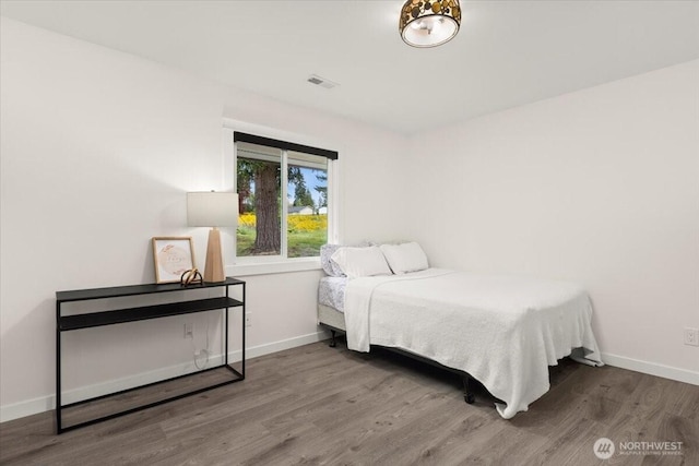 12125 E Woodland Ave, Puyallup, WA 98373 - bedroom with wood finished floors and baseboards