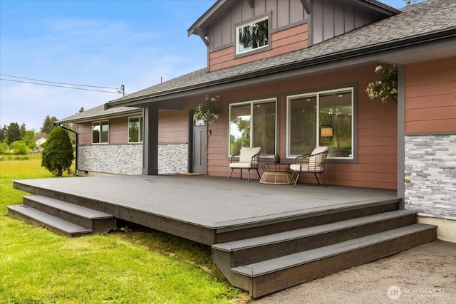 12125 E Woodland Ave, Puyallup, WA 98373 - back of property featuring a yard, a shingled roof, a wooden deck, and board and batten siding