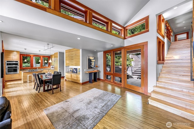 891 E Lake Samish Dr, Bellingham, WA 98229 - entryway with light wood-style floors, stairway, baseboards, high vaulted ceiling, and recessed lighting