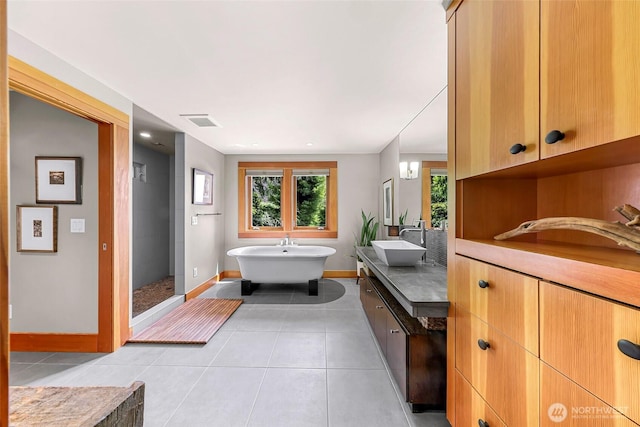 891 E Lake Samish Dr, Bellingham, WA 98229 - bathroom with vanity, baseboards, tile patterned floors, and a freestanding tub