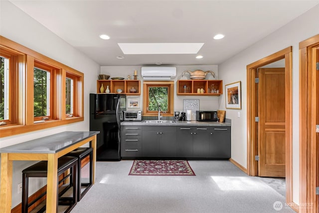891 E Lake Samish Dr, Bellingham, WA 98229 - kitchen with black appliances, open shelves, a skylight, a sink, and recessed lighting