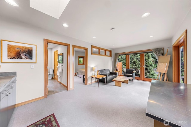 891 E Lake Samish Dr, Bellingham, WA 98229 - living room featuring french doors, light carpet, recessed lighting, baseboards, and a skylight