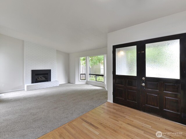 25705 117th Pl SE, Kent, WA 98030 - entryway featuring a fireplace, light wood-style flooring, baseboards, and light colored carpet