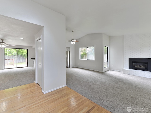 25705 117th Pl SE, Kent, WA 98030 - unfurnished living room featuring ceiling fan, a fireplace, carpet flooring, and lofted ceiling