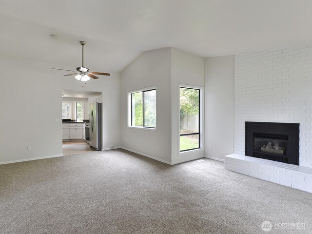 25705 117th Pl SE, Kent, WA 98030 - unfurnished living room featuring light carpet, a ceiling fan, baseboards, lofted ceiling, and a fireplace
