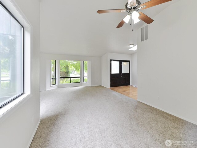 25705 117th Pl SE, Kent, WA 98030 - unfurnished living room with light colored carpet, baseboards, high vaulted ceiling, and a ceiling fan