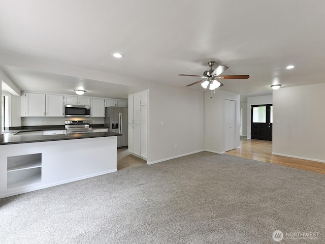 25705 117th Pl SE, Kent, WA 98030 - kitchen featuring appliances with stainless steel finishes, light carpet, dark countertops, open floor plan, and recessed lighting
