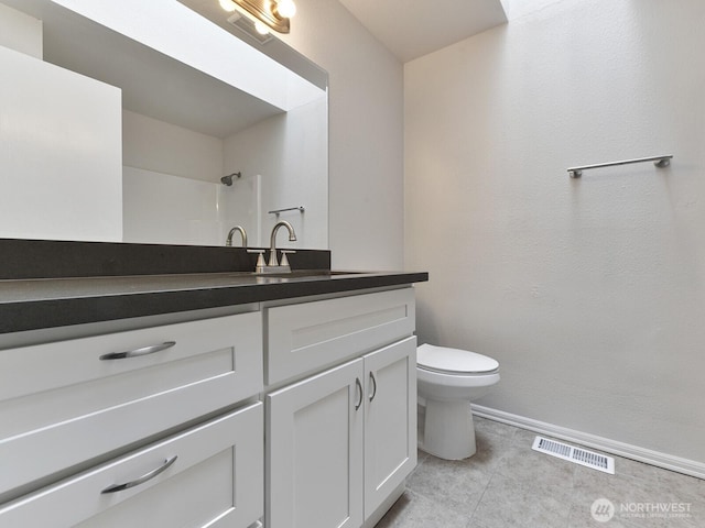 25705 117th Pl SE, Kent, WA 98030 - bathroom with toilet, vanity, baseboards, tile patterned flooring, and a shower