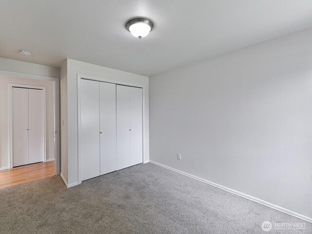 25705 117th Pl SE, Kent, WA 98030 - unfurnished bedroom with carpet floors, baseboards, and a closet