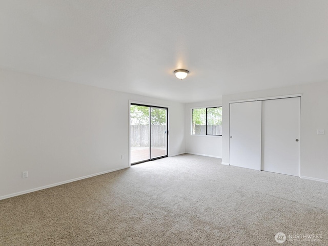 25705 117th Pl SE, Kent, WA 98030 - unfurnished bedroom featuring access to outside, carpet flooring, and baseboards
