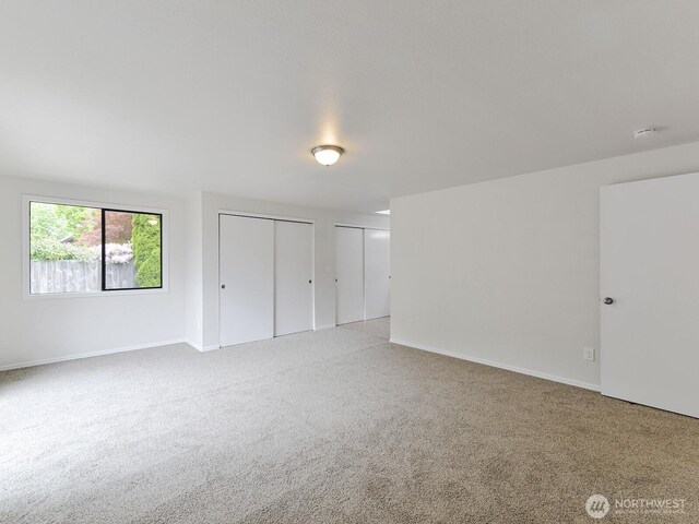 25705 117th Pl SE, Kent, WA 98030 - unfurnished bedroom featuring two closets, carpet flooring, and baseboards