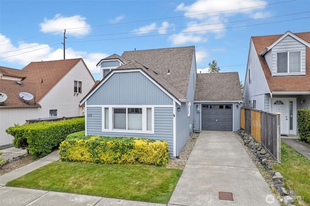 125 99th Street Ct E, Tacoma, WA 98445 - view of front of home featuring concrete driveway, a garage, and a shingled roof