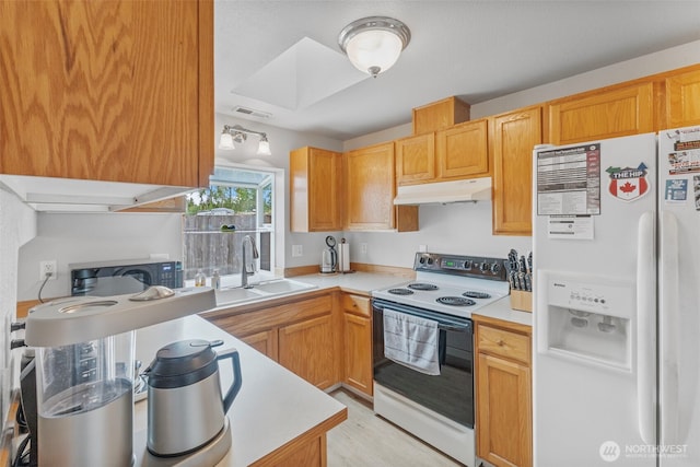 125 99th Street Ct E, Tacoma, WA 98445 - kitchen featuring white refrigerator with ice dispenser, electric range oven, under cabinet range hood, black microwave, and light countertops