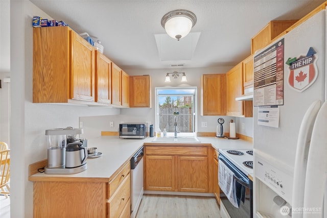125 99th Street Ct E, Tacoma, WA 98445 - kitchen featuring white appliances, a sink, light countertops, light wood-style floors, and under cabinet range hood