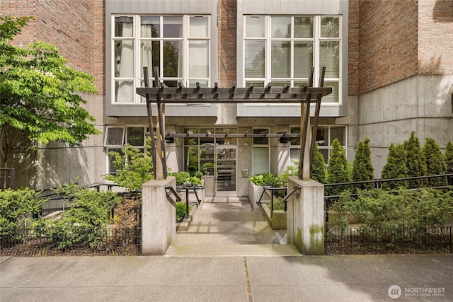 1812 19th Ave Unit 205, Seattle, WA 98122 - property entrance featuring a pergola and brick siding