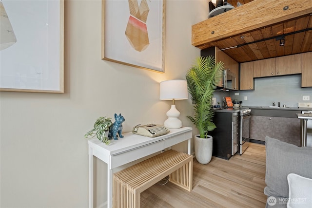 1812 19th Ave Unit 205, Seattle, WA 98122 - kitchen featuring stainless steel appliances, light wood-style flooring, and a sink