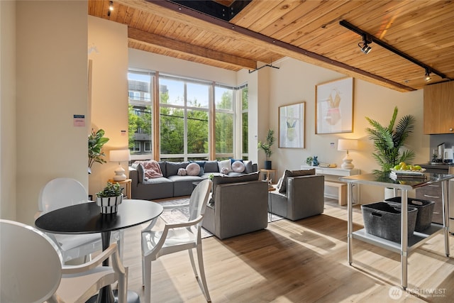 1812 19th Ave Unit 205, Seattle, WA 98122 - living room with wood ceiling with exposed beams, track lighting, and light wood-style flooring