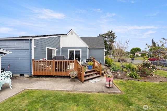367 Colorado St, Longview, WA 98632 - back of property featuring board and batten siding, a wooden deck, a yard, and a patio area