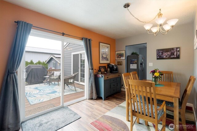367 Colorado St, Longview, WA 98632 - dining space with a chandelier and light wood-type flooring