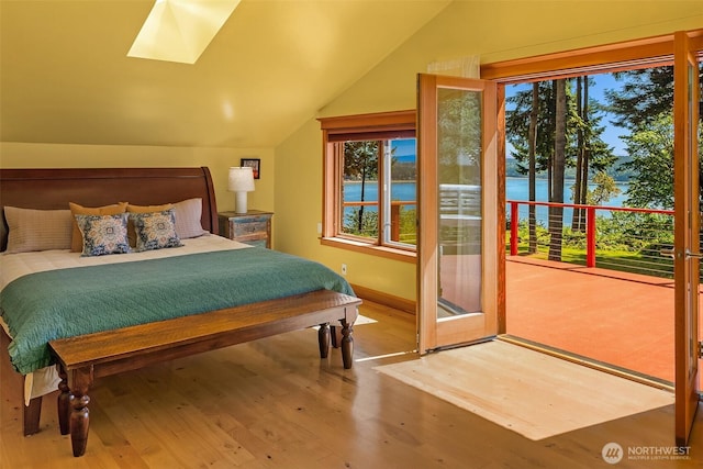 12010 SW Wesleyan Way Unit 1, Vashon, WA 98070 - bedroom with vaulted ceiling, a skylight, wood finished floors, multiple windows, and baseboards
