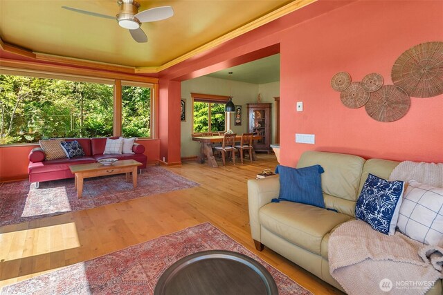 12010 SW Wesleyan Way Unit 1, Vashon, WA 98070 - living area with wood finished floors, a ceiling fan, and baseboards