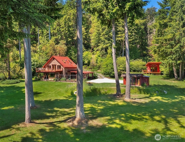 12010 SW Wesleyan Way Unit 1, Vashon, WA 98070 - view of grassy yard with a view of trees and a deck
