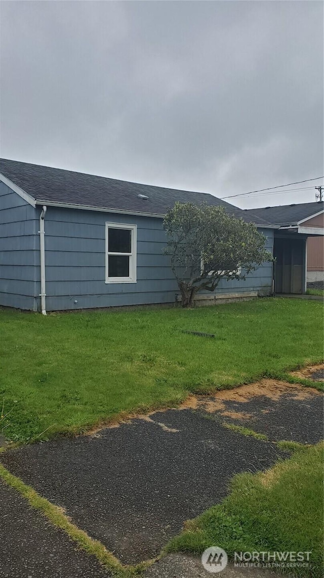 2210 Aberdeen Ave, Hoquiam, WA 98550 - view of home's exterior featuring a yard and roof with shingles