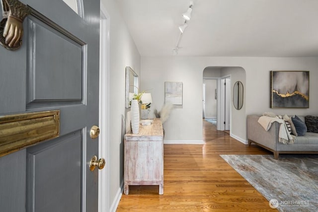 6050 36th Ave SW, Seattle, WA 98126 - foyer with arched walkways, light wood-style floors, track lighting, and baseboards