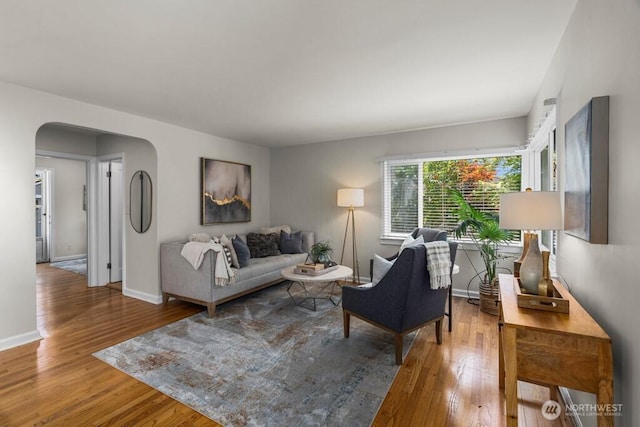 6050 36th Ave SW, Seattle, WA 98126 - living room with arched walkways, wood finished floors, and baseboards