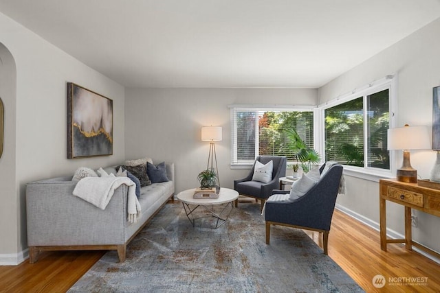 6050 36th Ave SW, Seattle, WA 98126 - living area with wood finished floors, arched walkways, and baseboards