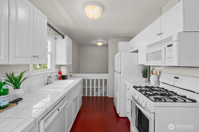 6050 36th Ave SW, Seattle, WA 98126 - kitchen featuring white appliances, a sink, tile countertops, and white cabinetry