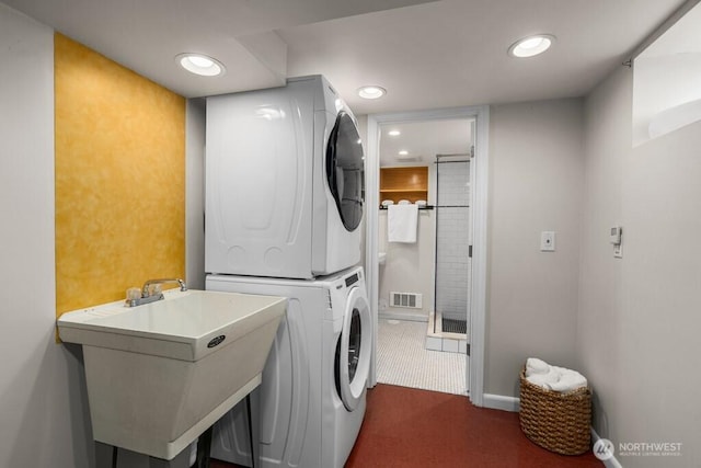 6050 36th Ave SW, Seattle, WA 98126 - laundry area with stacked washer / dryer, dark colored carpet, recessed lighting, and baseboards