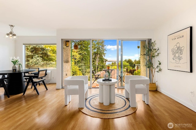 11515 Greenwood Ave N Unit C, Seattle, WA 98133 - dining space featuring wood finished floors, a chandelier, and baseboards