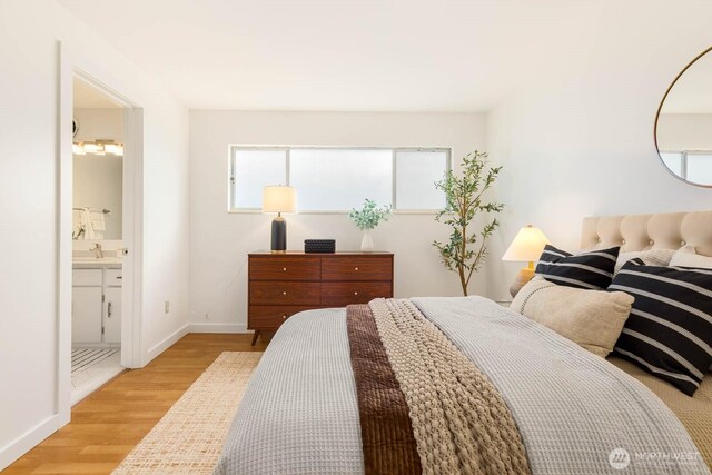 11515 Greenwood Ave N Unit C, Seattle, WA 98133 - bedroom featuring wood finished floors, baseboards, a sink, and connected bathroom