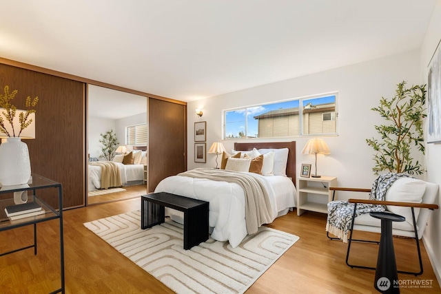 11515 Greenwood Ave N Unit C, Seattle, WA 98133 - bedroom featuring multiple windows, wood finished floors, and a closet