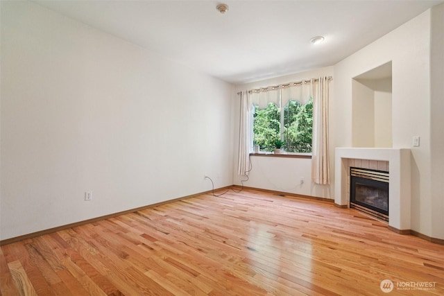2419 S Meridian Unit B8, Puyallup, WA 98373 - unfurnished living room with light wood finished floors and a tile fireplace