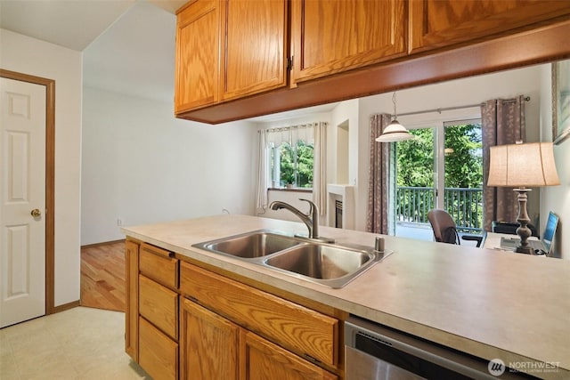 2419 S Meridian Unit B8, Puyallup, WA 98373 - kitchen with stainless steel dishwasher, light countertops, plenty of natural light, and brown cabinetry