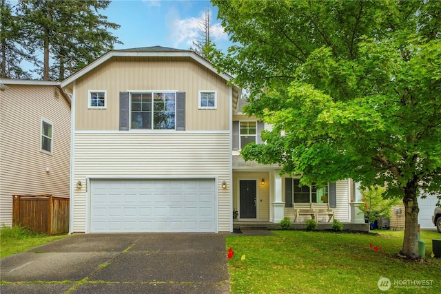 traditional-style home featuring asphalt driveway and a garage