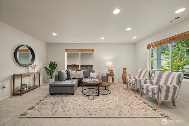 carpeted living area featuring recessed lighting and baseboards
