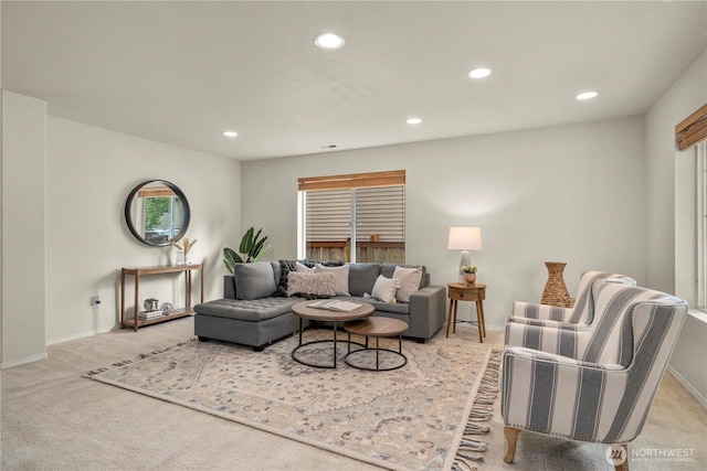 living area featuring recessed lighting, baseboards, and light carpet