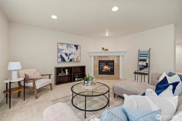 living room featuring light colored carpet, a fireplace, baseboards, and recessed lighting